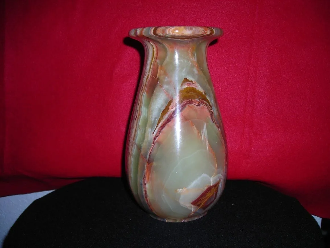 Marble vase with red and green patterns.