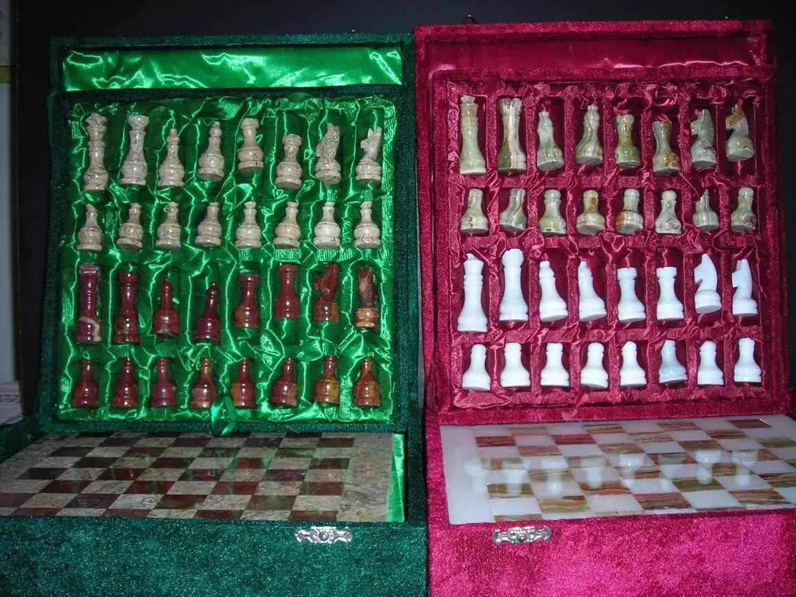Two luxurious chess sets with open cases.