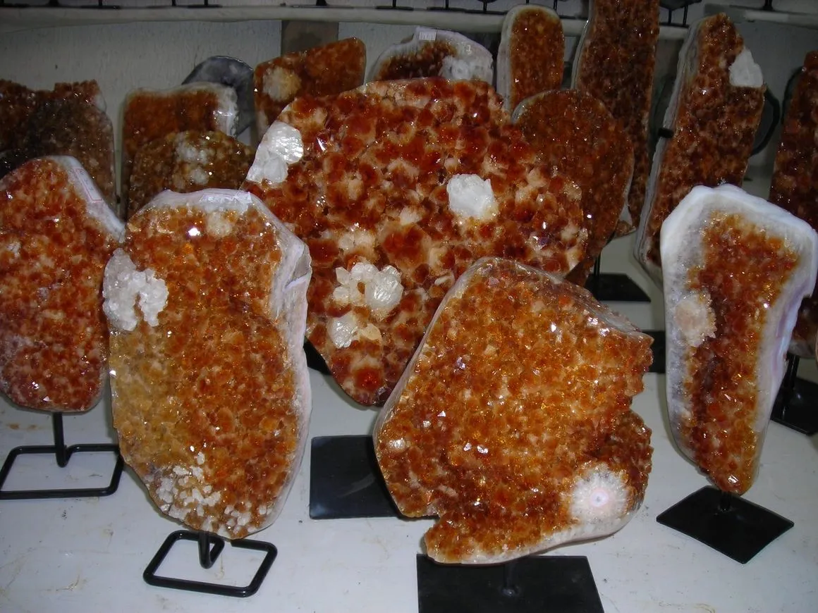 Clusters of orange citrine crystals on display.
