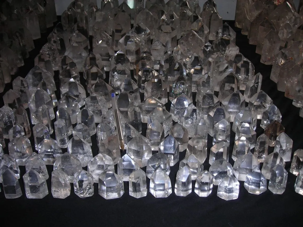 Clear quartz crystal points on display table.