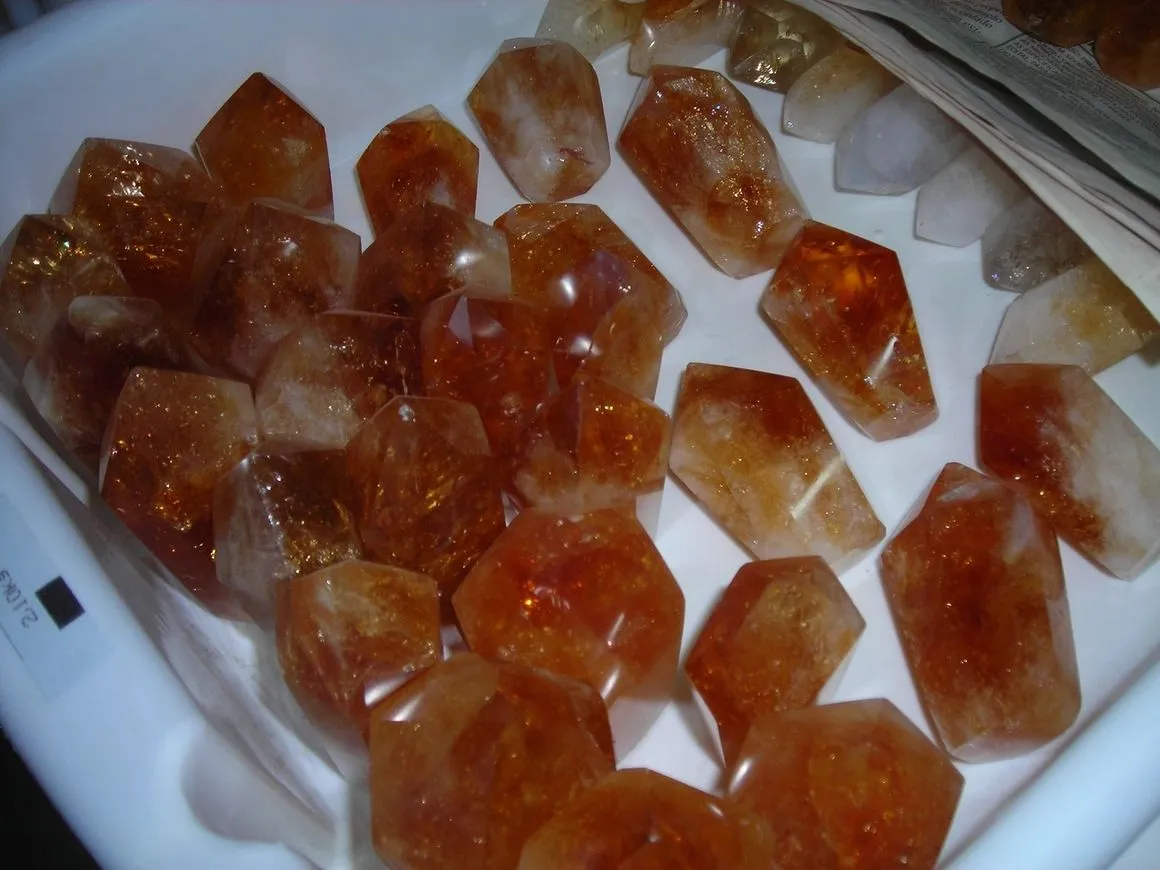 Orange crystals displayed in a white tray.