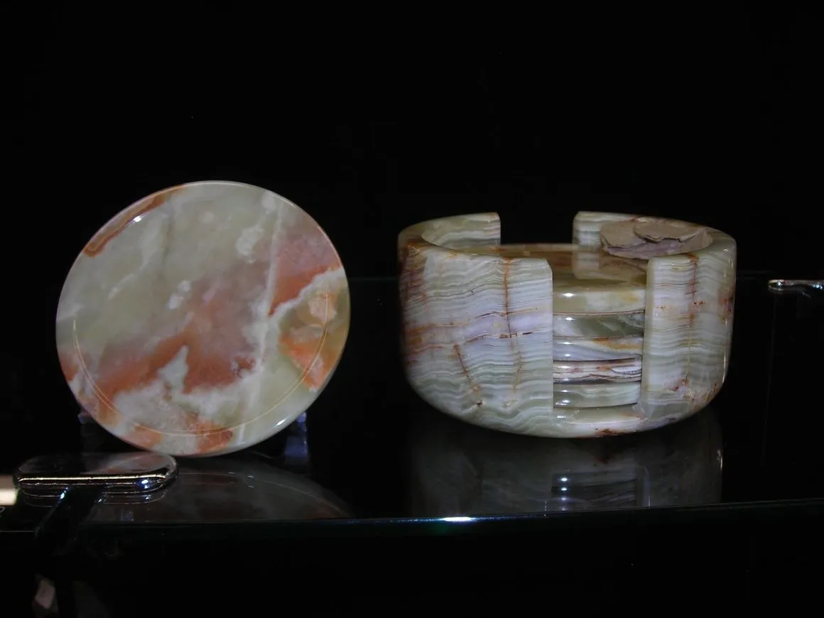 Stone coaster and holder on black background.