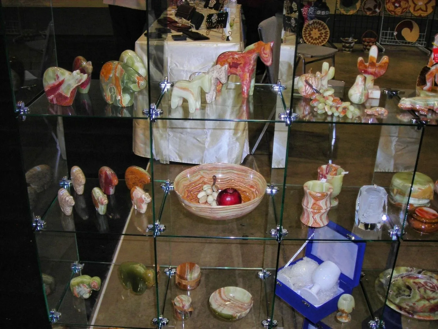 Glass display case with carved stone figures.